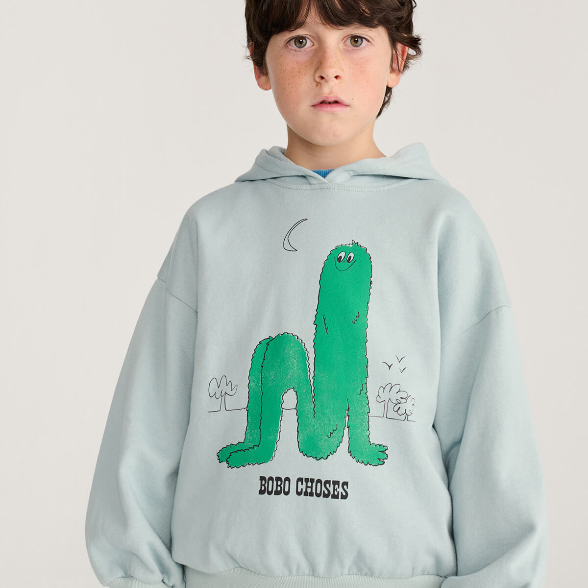 Sweat à capuche en coton bio imprimé bleu clair ludique à manches longues bouffantes avec poignets côtelés, conçu pour les enfants de 1 à 13 ans